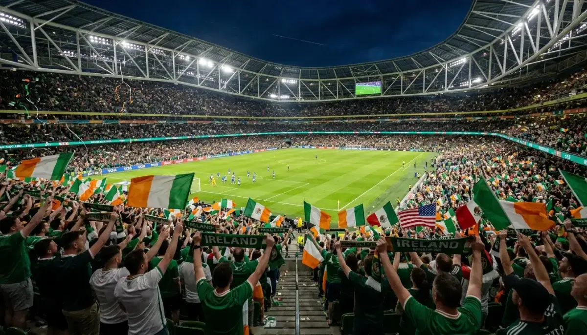 Lucht féachana i staidiam mór ag Corn an Domhain 2026 le bratacha náisiúnta agus páirc ghlas sacair